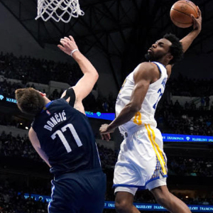 Photo of Andrew Wiggins dunking over Luka Doncic