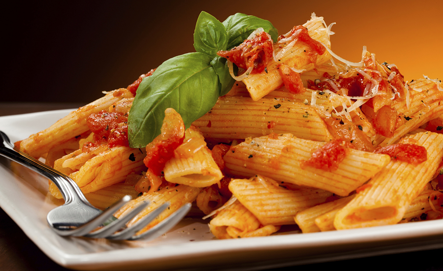 Photo of mostaccioli pasta on a plate.